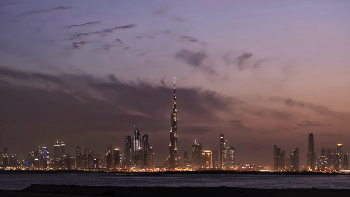 The Gulf skyline at dusk, seen across the water
